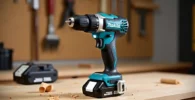 A Makita XFD131 brushless drill with a battery on a wooden workbench, with wood shavings nearby. The image highlights the compact design of the cordless tool. Tested on tool tested.