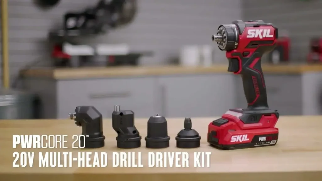 The Skil PWRCore 20V multi-head drill and its various attachments are laid out on a workbench, showcasing the versatility of the kit.