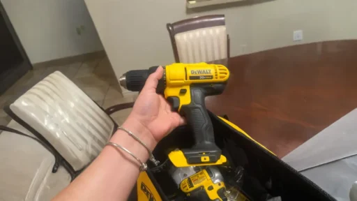 A hand holding a DeWalt cordless drill, emphasizing the ergonomic design often found in budget vs premium power tools.