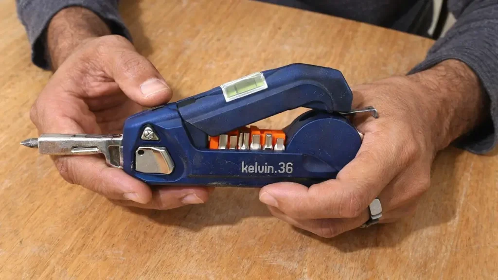 A mobile‑captured photo of the Kelvin 36 Urban Multi‑Tool placed on a wooden table, reviewed for the Kelvin 36 Urban Multi‑Tool Review on Tool Tested.