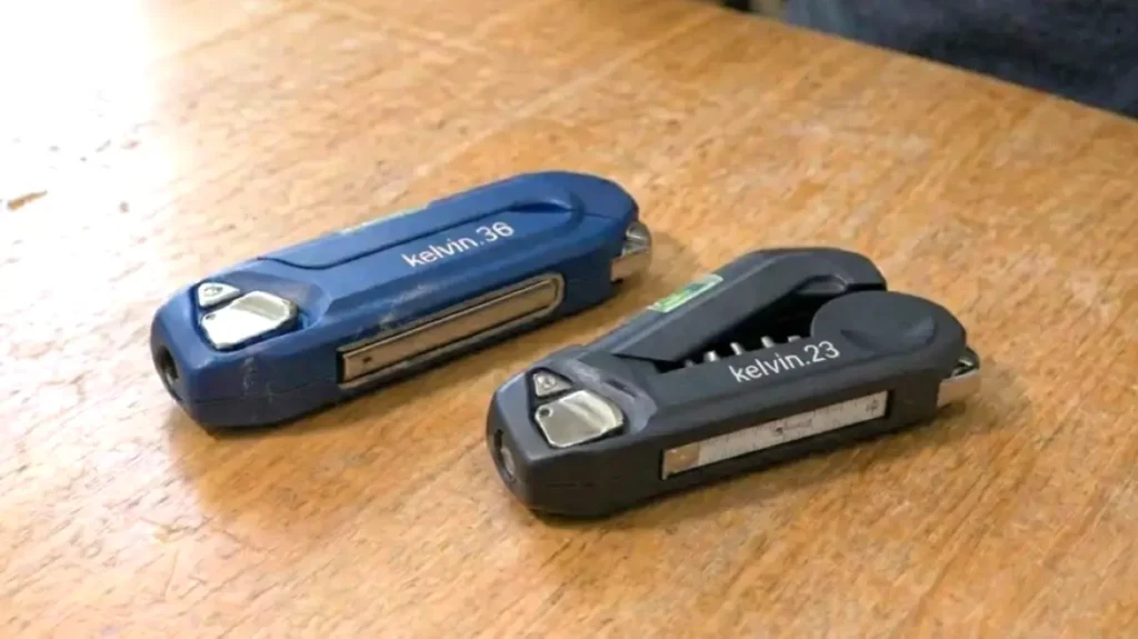 Two multi‑tools placed side by side on a table for comparison.